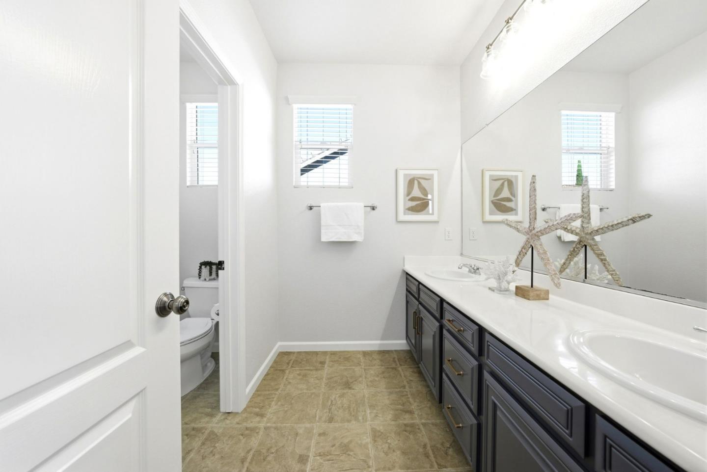 2556 Harlow Lane San Ramon, CA 94582 - Photo 43 of 62 a spacious bathroom with a granite countertop sink a toilet and a mirror