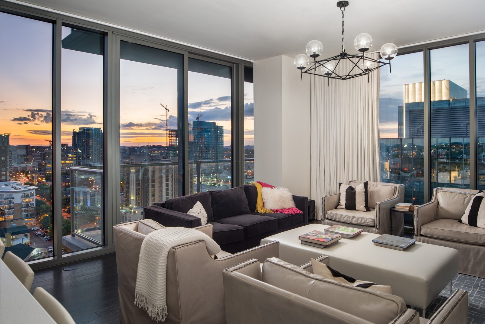 a living room with furniture and a chandelier