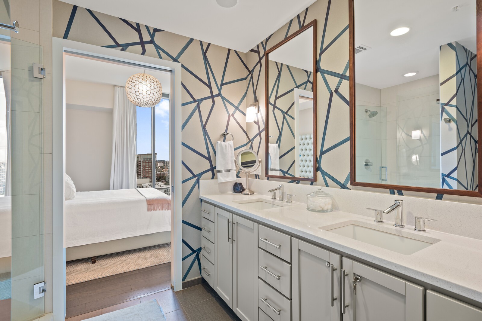 1212 Laurel Street, Unit 1815 Nashville, TN 37203 - Photo 13 of 26 a bathroom with a double vanity sink a mirror and a bathtub