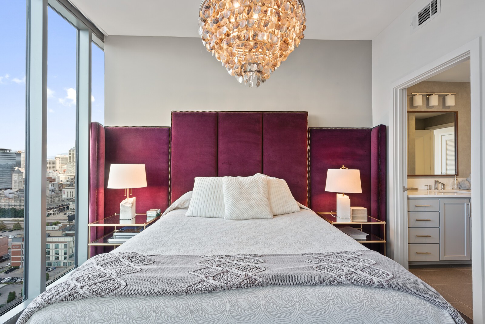 1212 Laurel Street, Unit 1815 Nashville, TN 37203 - Photo 15 of 26 a bedroom with a large bed and wooden floor