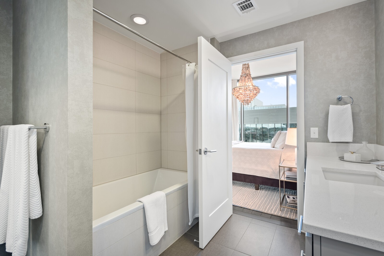 1212 Laurel Street, Unit 1815 Nashville, TN 37203 - Photo 16 of 26 a bathroom with a tub sink and mirror