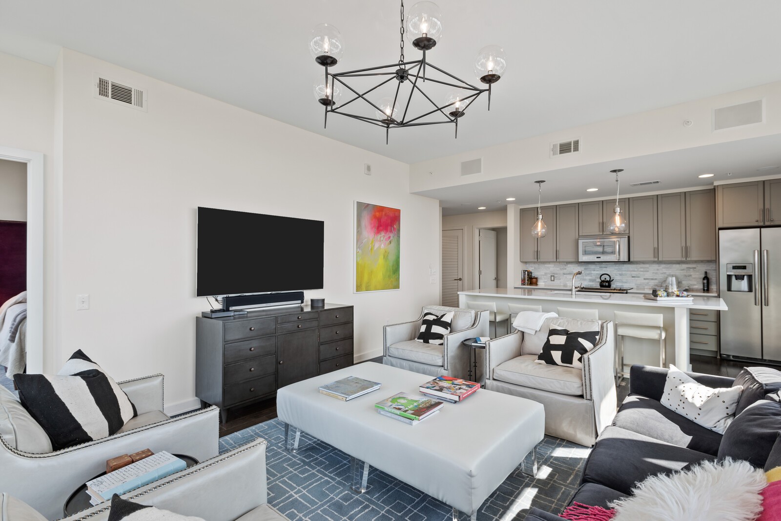 1212 Laurel Street, Unit 1815 Nashville, TN 37203 - Photo 4 of 26 a living room with furniture a flat screen tv and kitchen view