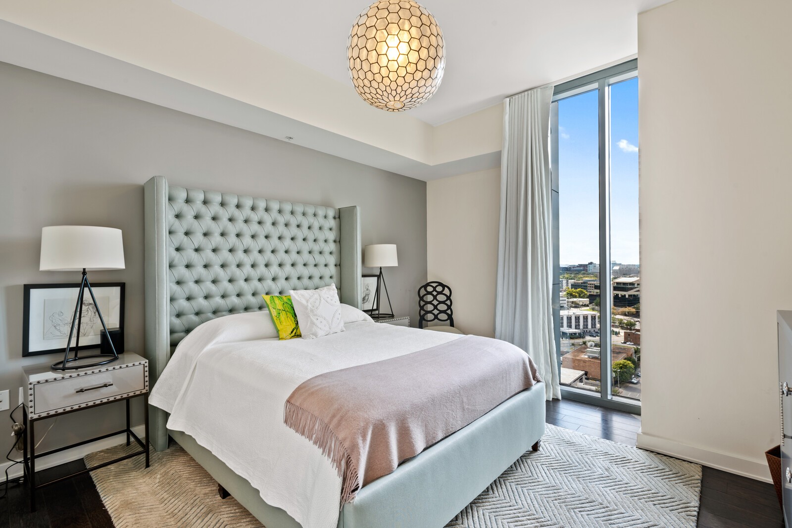 1212 Laurel Street, Unit 1815 Nashville, TN 37203 - Photo 10 of 26 a bedroom with a bed a table and painting on the wall