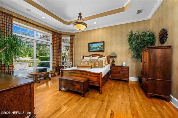 a living room with furniture a chandelier and a flat screen tv