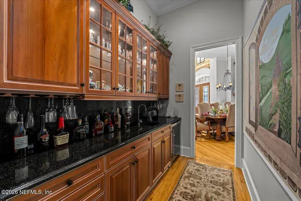 a bathroom with a stove a sink and a shower