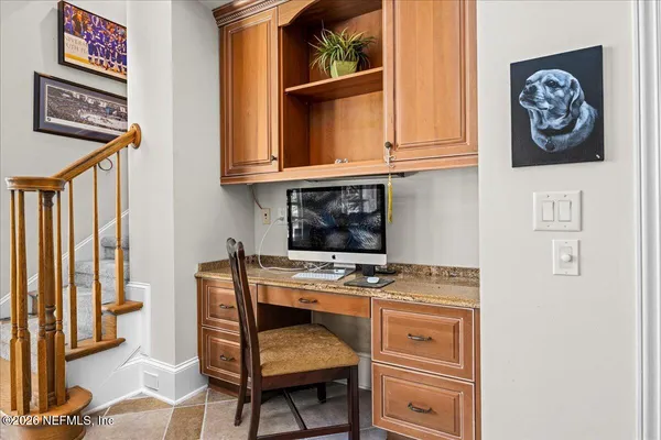 an aerial view of residential houses with outdoor space and trees