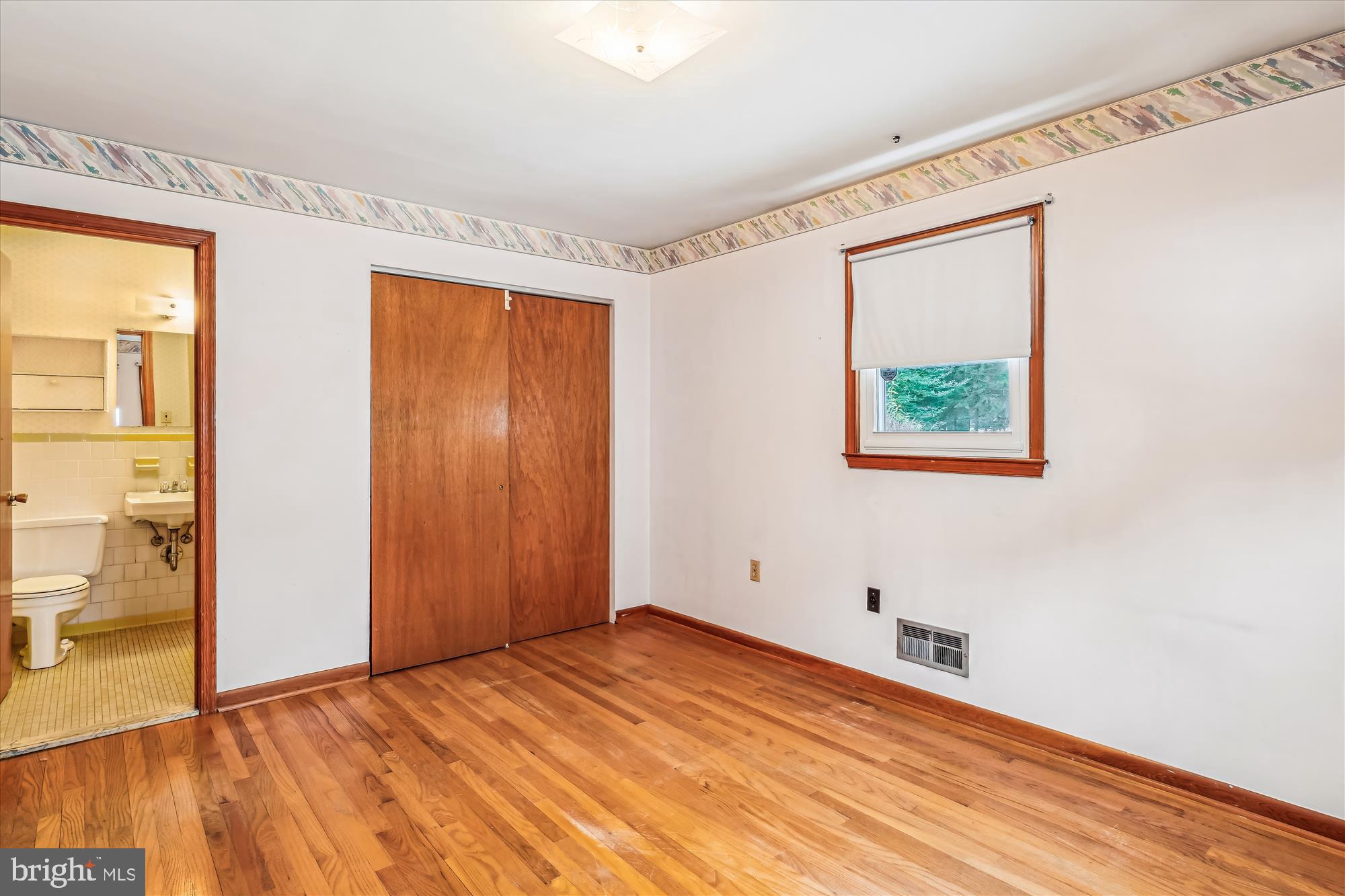 1418 Larch Road Severn, MD 21144 - Photo 20 of 36 a view of an empty room with wooden floor and a window