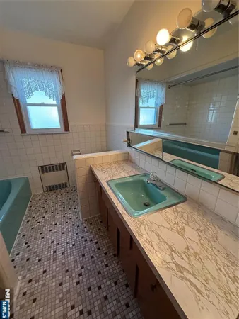 a kitchen with a sink a counter top space and cabinets