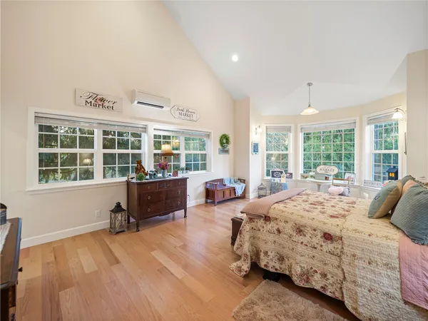 a bedroom with a bed a chandelier and a window