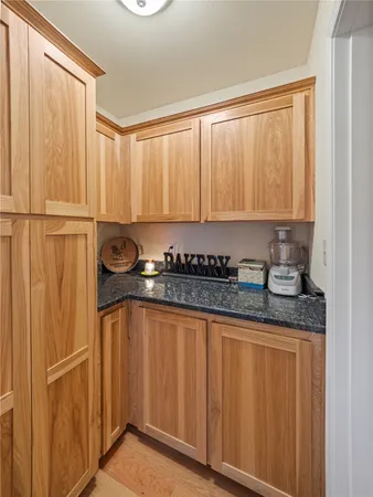 a large kitchen with stainless steel appliances granite countertop a stove and cabinets