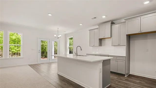 a kitchen with stainless steel appliances granite countertop a sink a stove and a refrigerator