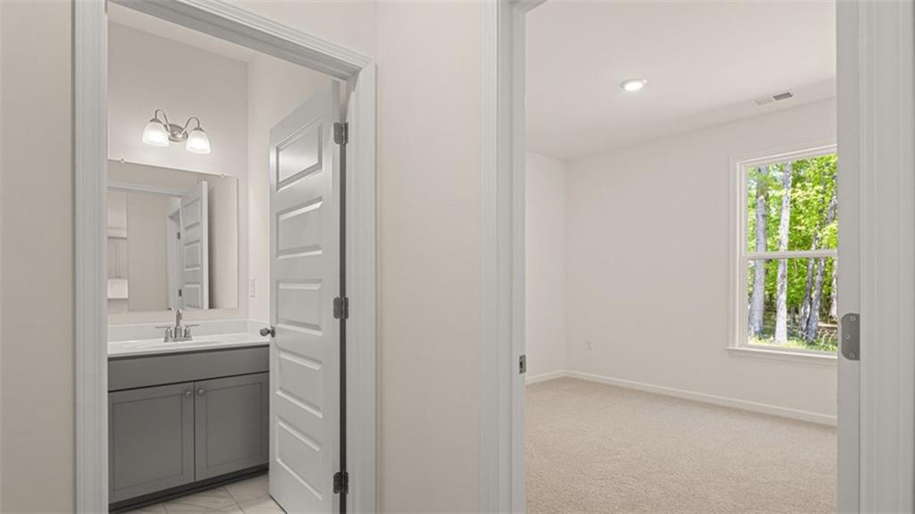 13586 Whitman Lane Covington, GA 30014 - Photo 27 of 50 a bathroom with a sink and a mirror
