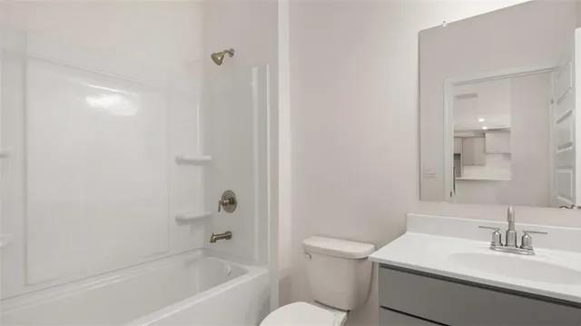 an empty room with windows and a ceiling fan