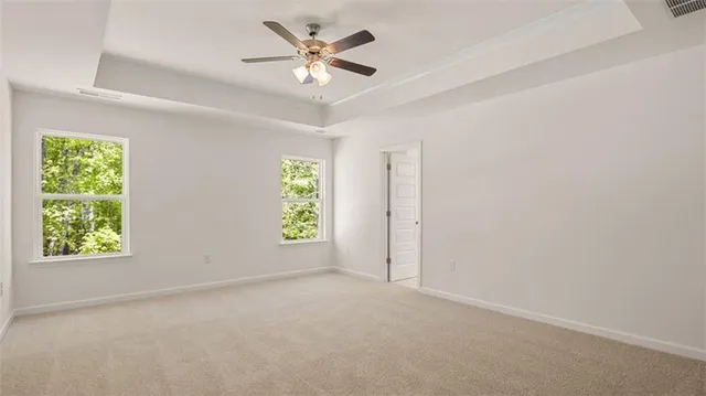 a view of a livingroom with a ceiling fan and entryway