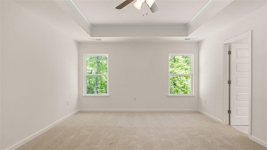 13586 Whitman Lane Covington, GA 30014 - Photo 32 of 50 an empty room with windows and a ceiling fan