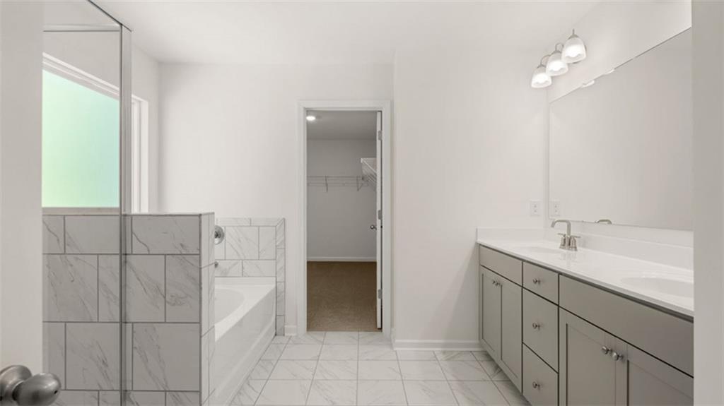 13586 Whitman Lane Covington, GA 30014 - Photo 34 of 50 a bathroom with a double vanity sink a and a mirror