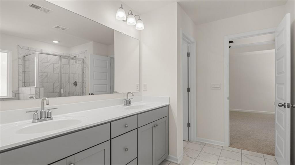 13586 Whitman Lane Covington, GA 30014 - Photo 35 of 50 a bathroom with double sink and a mirror
