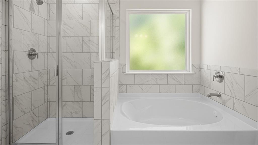 13586 Whitman Lane Covington, GA 30014 - Photo 36 of 50 a white bath tub sitting next to a window