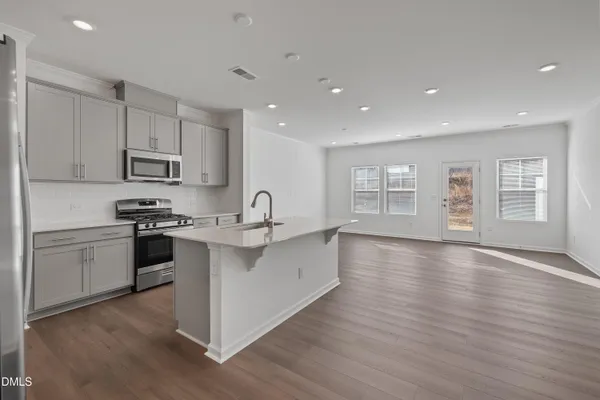 a kitchen with stainless steel appliances a refrigerator and a stove