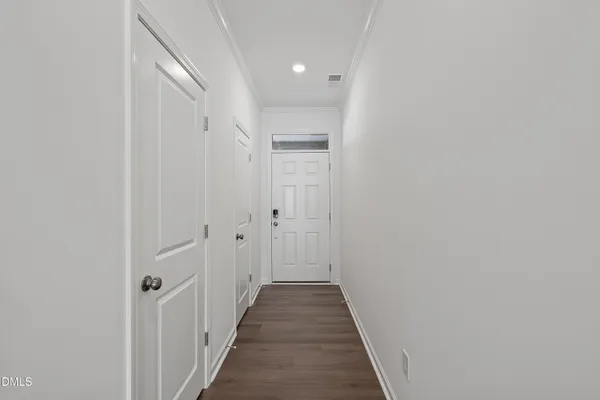a view of a hallway with wooden floor