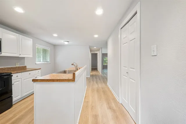 a kitchen with stainless steel appliances granite countertop a sink and cabinets
