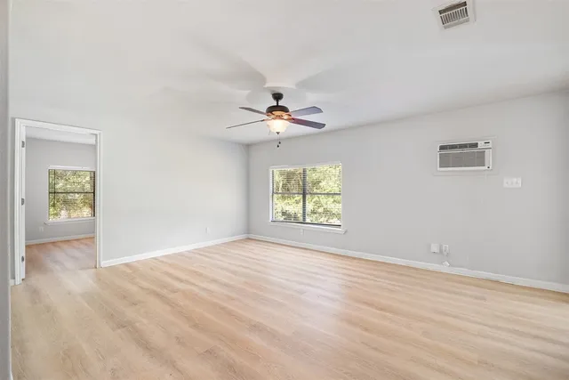 wooden floor in an empty room with a window