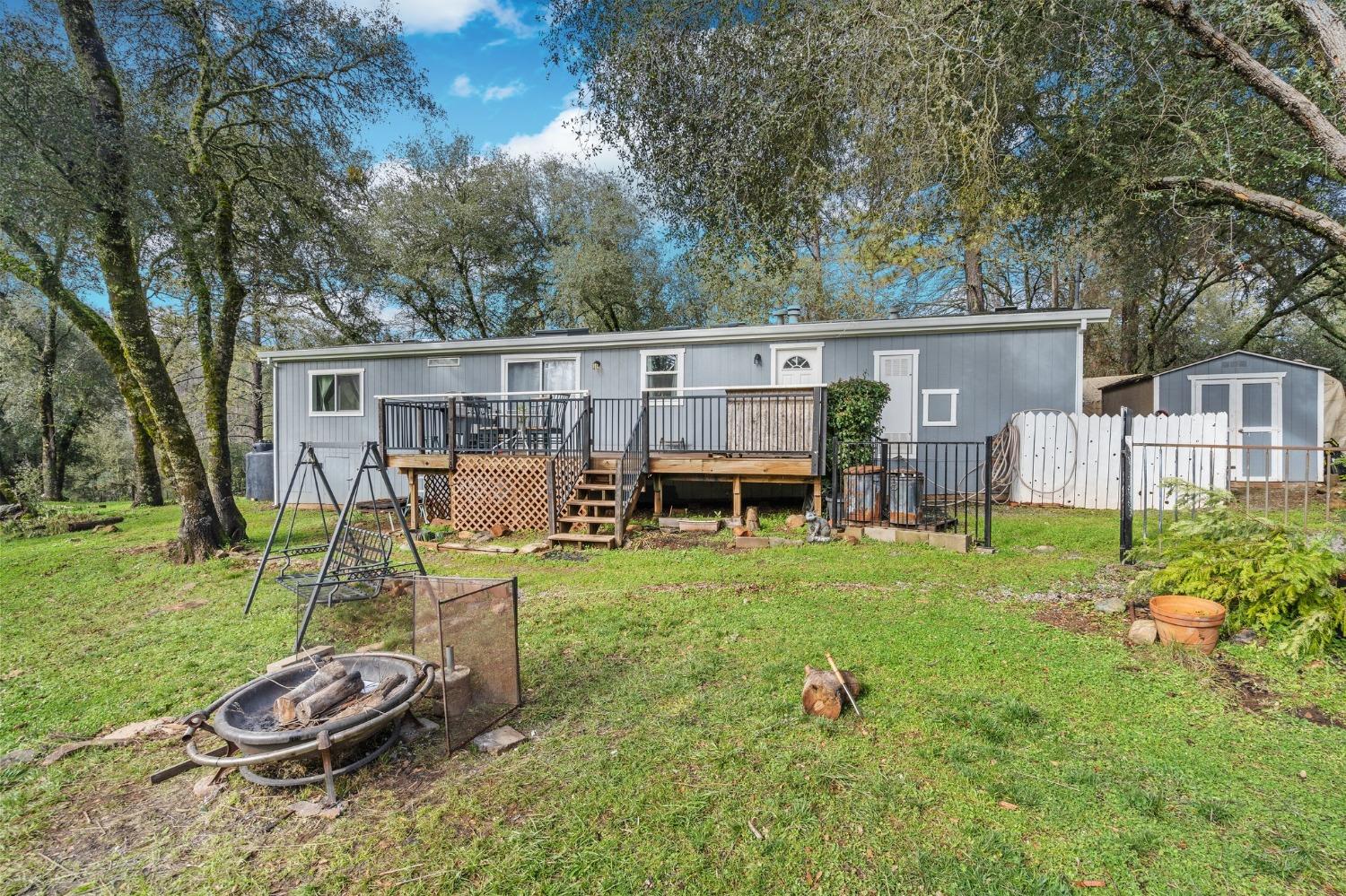 5347 Rattlesnake Bar Road Pilot Hill, CA 95664 - Photo 1 of 1 a backyard of a house with table and chairs