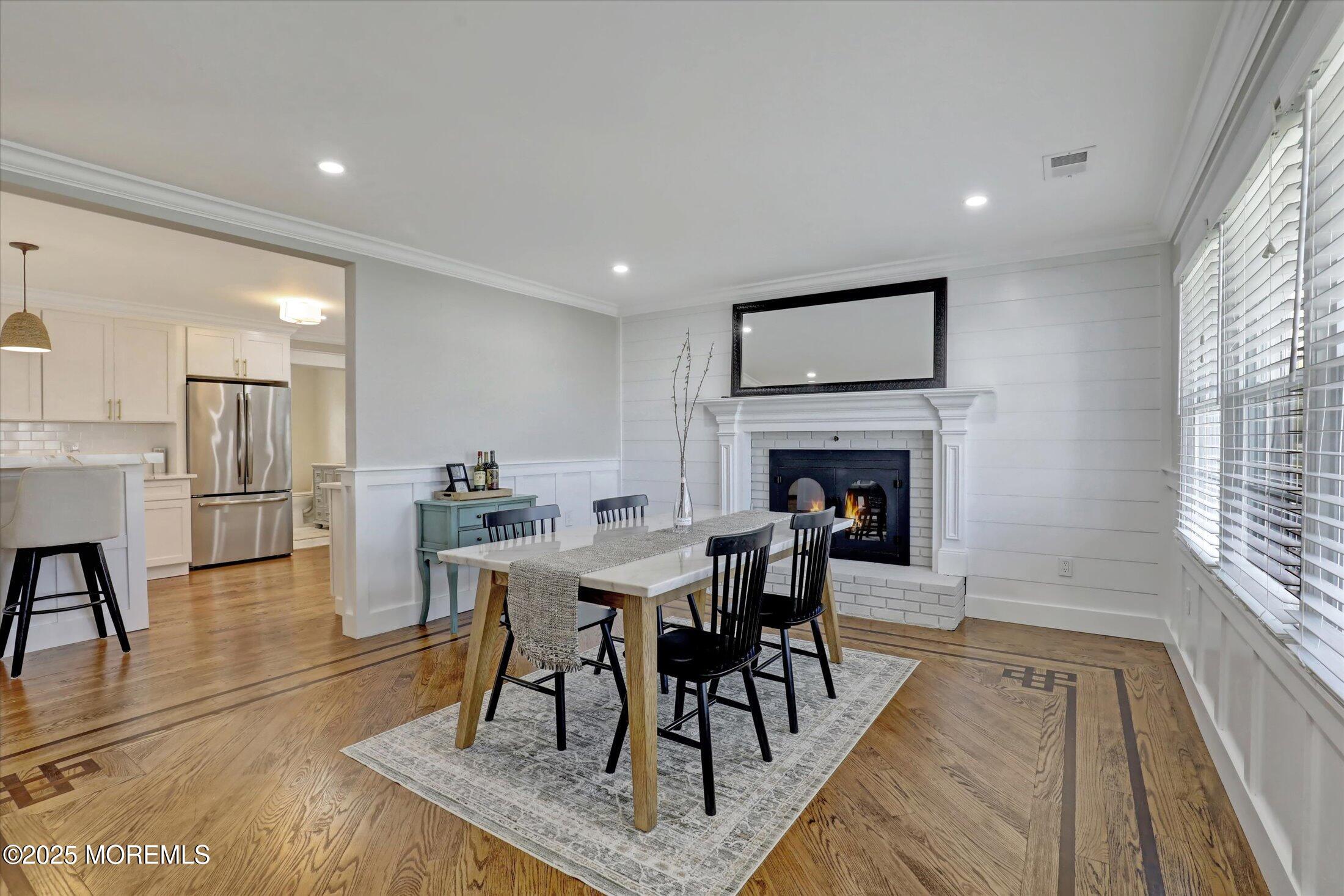 1810 Shore Boulevard Point Pleasant, NJ 08742 - Photo 14 of 49 a dining room with furniture a fireplace and wooden floor