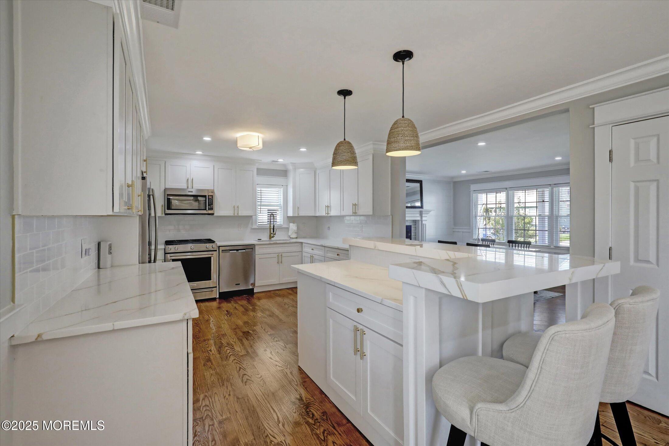 1810 Shore Boulevard Point Pleasant, NJ 08742 - Photo 17 of 49 a kitchen with kitchen island granite countertop a sink cabinets and stainless steel appliances