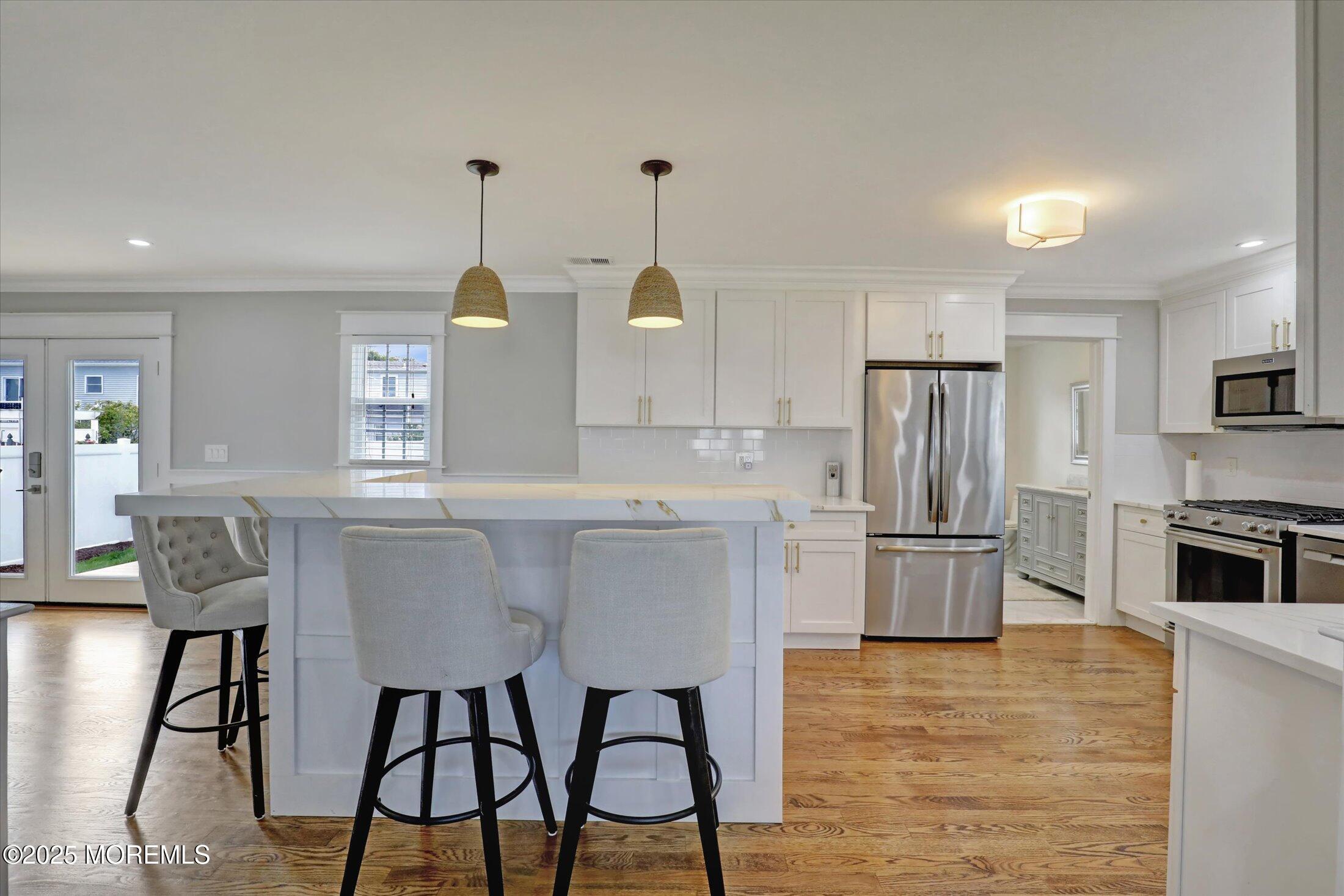 1810 Shore Boulevard Point Pleasant, NJ 08742 - Photo 18 of 49 a kitchen with kitchen island a refrigerator stove microwave and cabinets