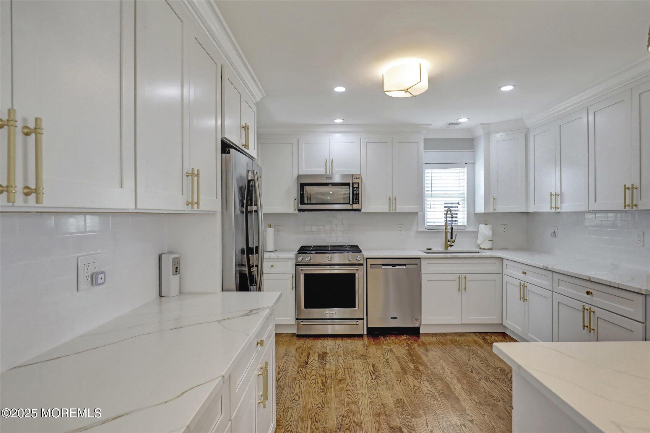 1810 Shore Boulevard Point Pleasant, NJ 08742 - Photo 22 of 49 a kitchen with granite countertop a sink stainless steel appliances and cabinets