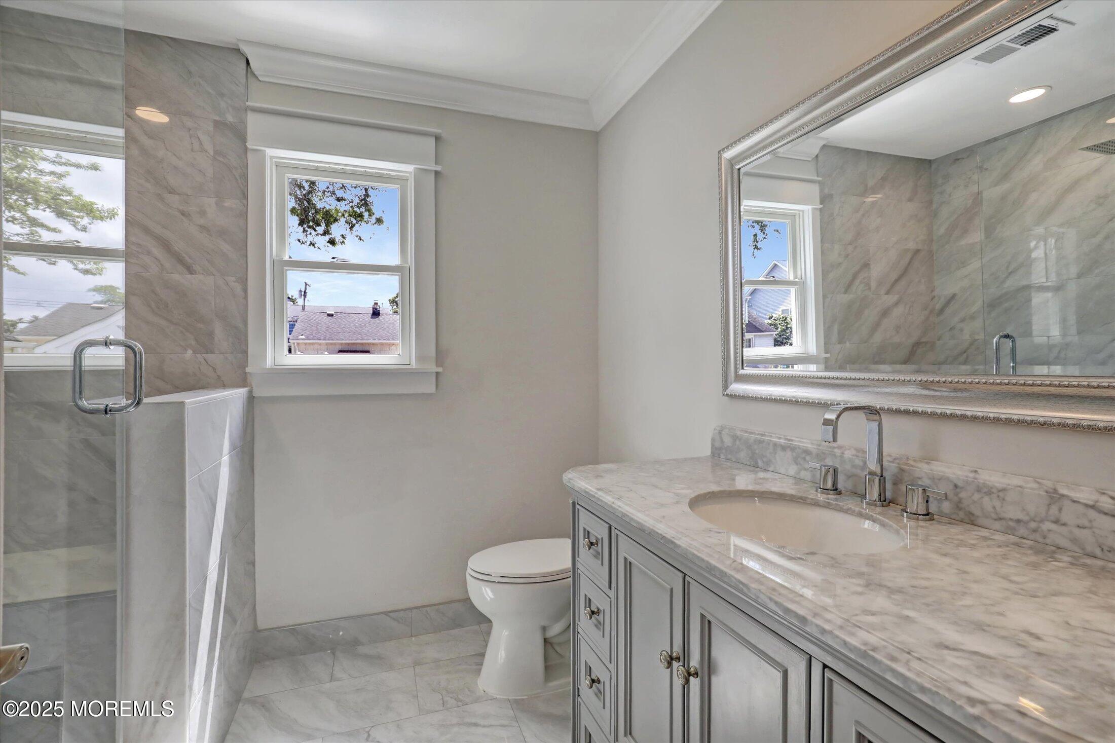 1810 Shore Boulevard Point Pleasant, NJ 08742 - Photo 28 of 49 a bathroom with a granite countertop sink toilet and a window
