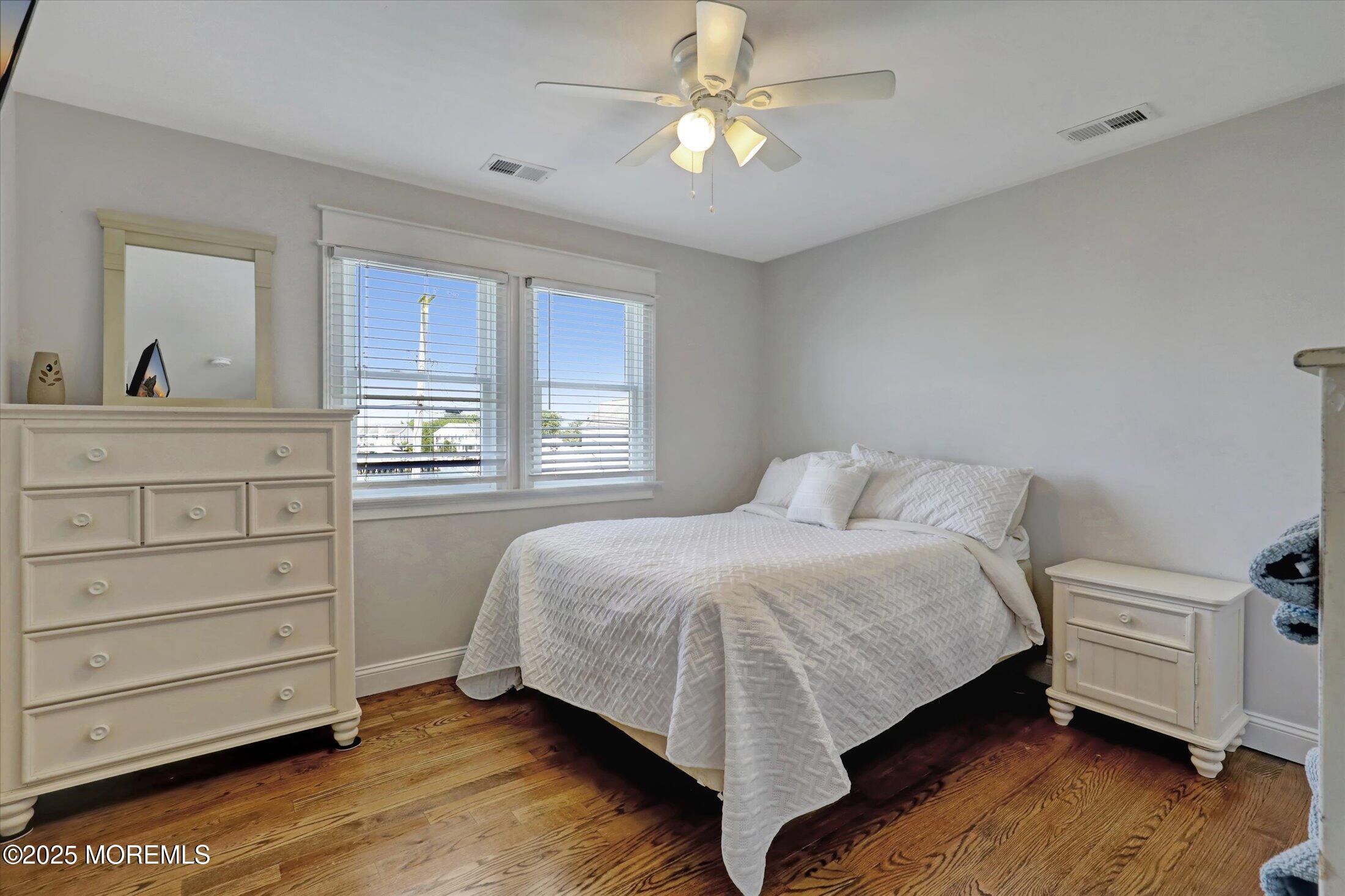 1810 Shore Boulevard Point Pleasant, NJ 08742 - Photo 31 of 49 a bedroom with a bed and a dresser