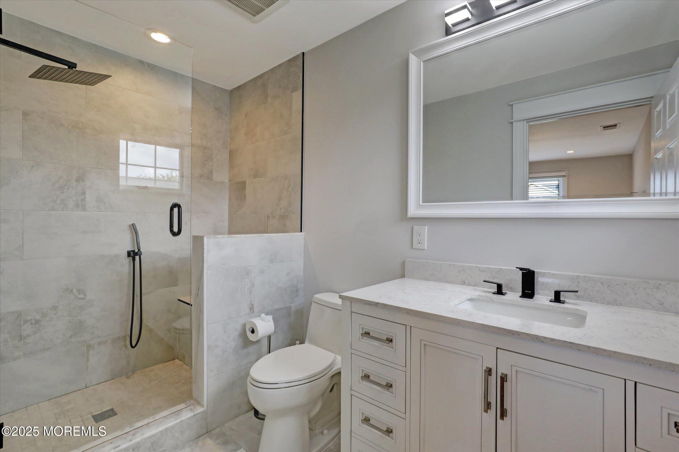 1810 Shore Boulevard Point Pleasant, NJ 08742 - Photo 38 of 49 a bathroom with a sink toilet and shower