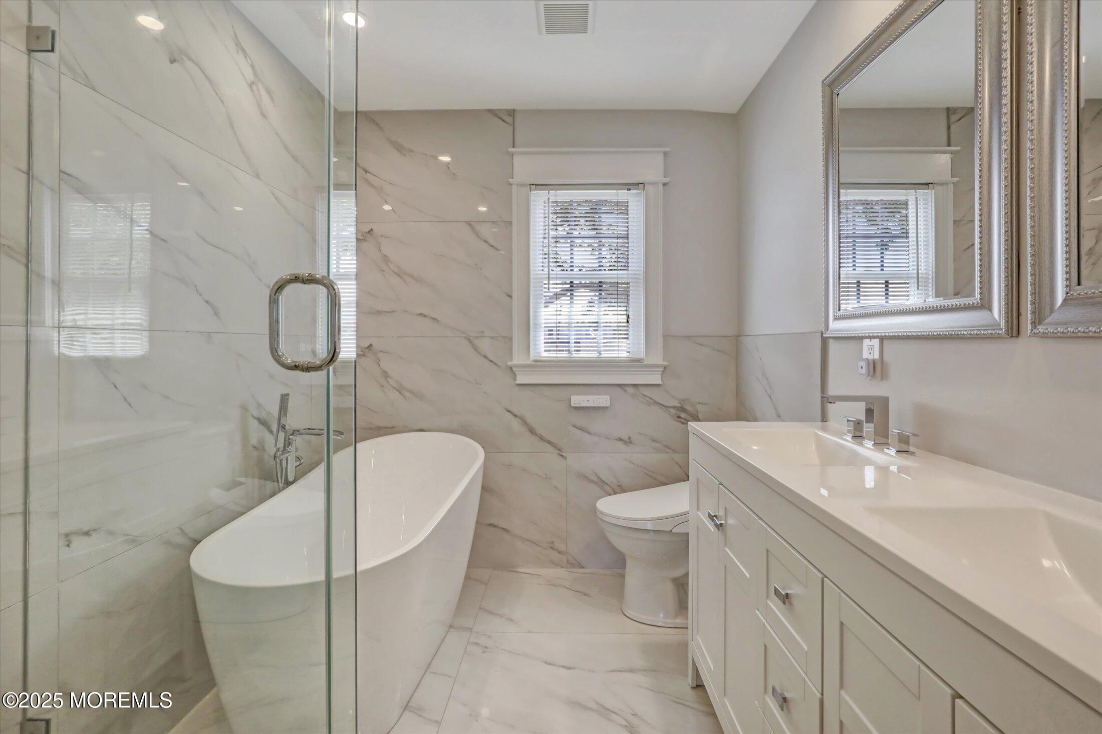 1810 Shore Boulevard Point Pleasant, NJ 08742 - Photo 39 of 49 a bathroom with a sink a toilet and shower
