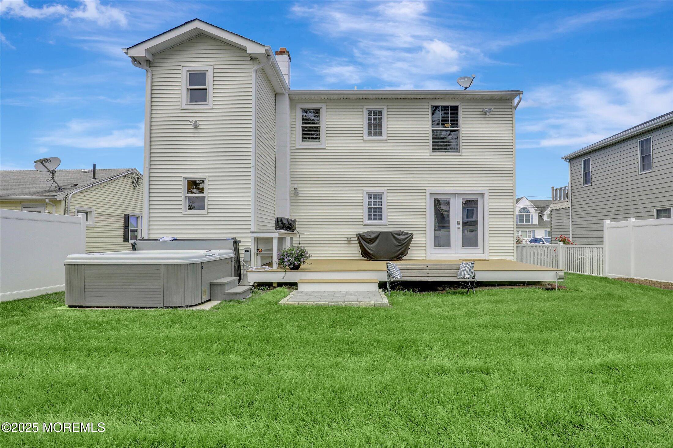 1810 Shore Boulevard Point Pleasant, NJ 08742 - Photo 41 of 49 a front view of a house with a yard and garage