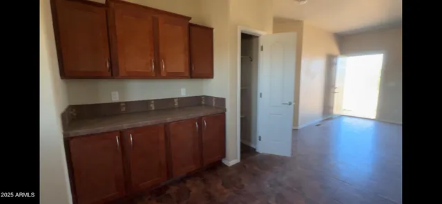 a view of wooden floor and windows in a room