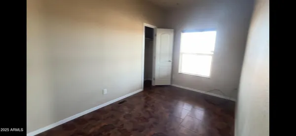 a view of wooden floor and windows in a room