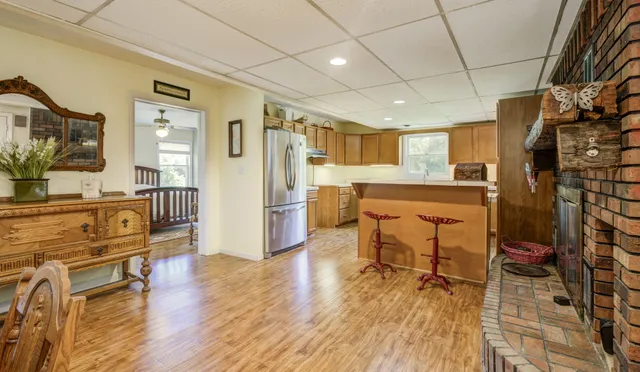 a view of hallway with a window and wooden floor
