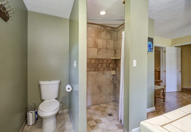 a view of a dining room with furniture and a chandelier