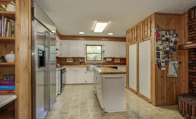 a bedroom with a large bed and a large window