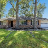 a view of a house with a backyard and a patio