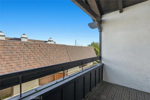 a view of balcony with wooden floor and fence