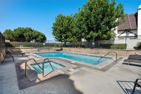 a swimming pool with outdoor seating and yard
