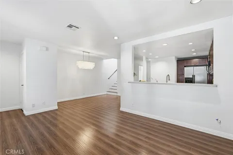 a view of kitchen with wooden floor and electronic appliances