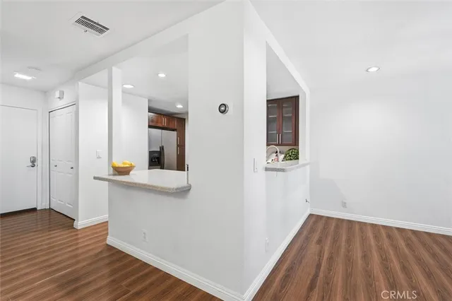 a kitchen with sink a microwave and cabinets