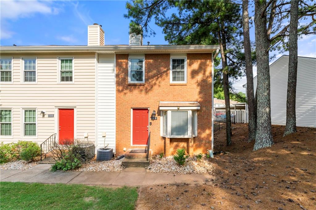 136 Holcomb Ferry Road Roswell, GA 30076 - Photo 1 of 1 a front view of a house with a yard