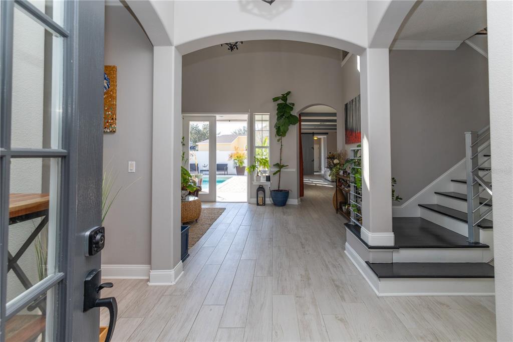 3305 Schoolhouse Road St. Cloud, FL 34773 - Photo 16 of 83 a view of a hallway view with wooden floor and staircase