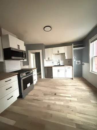 a kitchen with stainless steel appliances kitchen island wooden cabinets and granite counter tops
