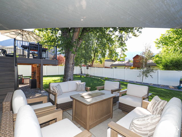 3308 Willow Ridge Road Salt Lake City, UT 84121 - Photo 11 of 59 Expansive backyard featuring a green lawn, white privacy fencing, and mature trees